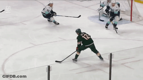 A Hockey Game Is Being Played In Front Of A Polaris Banner GIF