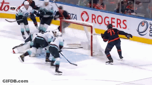 A Hockey Game Is Being Played In Front Of A Rogers Banner GIF