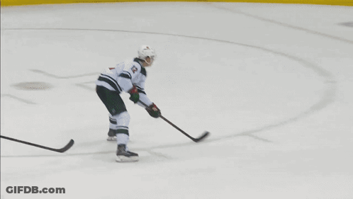 A Hockey Game Is Being Played In Front Of A Rwj Bank Sign GIF