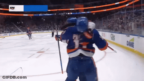 A Hockey Game Is Being Played In Front Of A Screen That Says Dime On It GIF