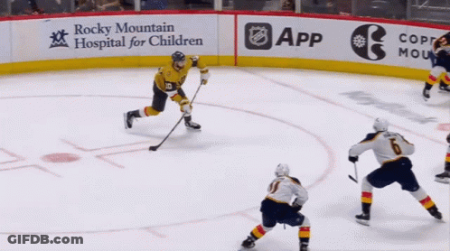 A Hockey Game Is Being Played In Front Of A Sign For Rocky Mountain Hospital For Children GIF