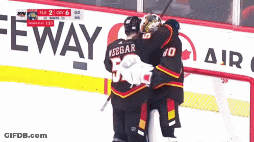 A Hockey Game Is Being Played In Front Of A Sign That Says Eway GIF