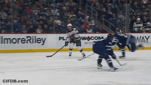 A Hockey Game Is Being Played In Front Of A Sign That Says Imore Riley GIF