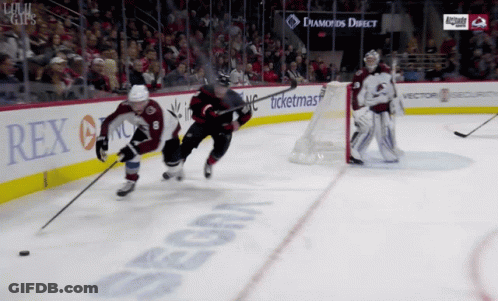 A Hockey Game Is Being Played In Front Of A Sign That Says Rex On It GIF