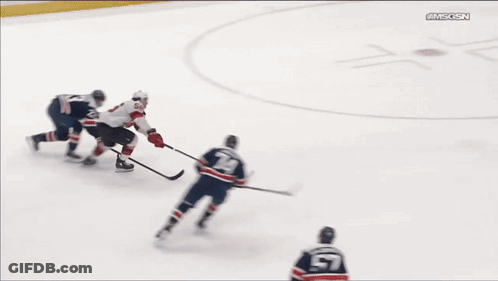 A Hockey Game Is Being Played In Front Of A Sign That Says Te-Syrup GIF