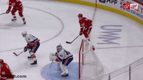 A Hockey Game Is Being Played In Front Of A Sign That Says Uvwm GIF