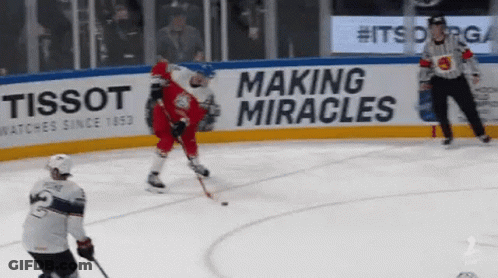 A Hockey Game Is Being Played In Front Of A Tissot Sign GIF