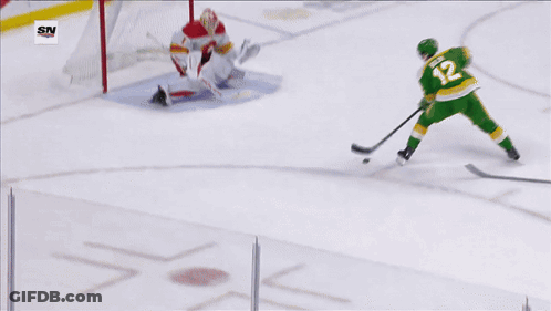 A Hockey Game Is Being Played In Front Of A Us Bank Banner GIF