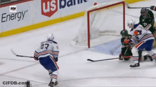 A Hockey Game Is Being Played In Front Of A Us Bank Banner GIF