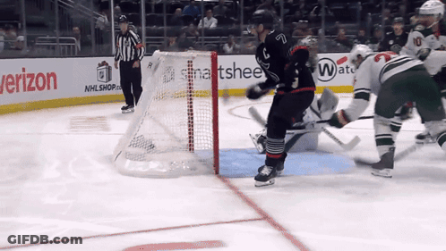 A Hockey Game Is Being Played In Front Of A Verizon Advertisement GIF