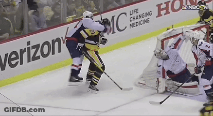 A Hockey Game Is Being Played In Front Of A Verizon Banner GIF