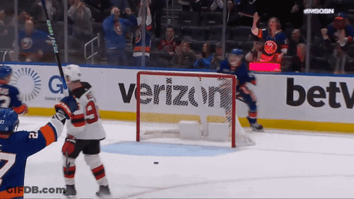 A Hockey Game Is Being Played In Front Of A Verizon Sign GIF