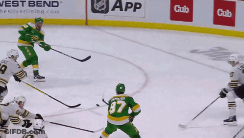 A Hockey Game Is Being Played In Front Of A West Bend Ad GIF