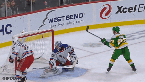 A Hockey Game Is Being Played In Front Of A West Bend Advertisement GIF