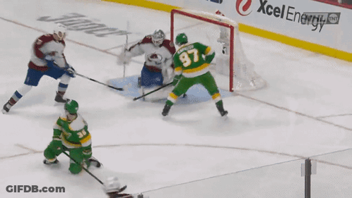 A Hockey Game Is Being Played In Front Of A Xcel Energy Sign GIF