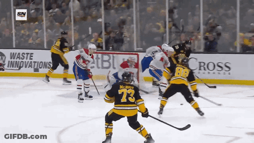 A Hockey Game Is Being Played In Front Of An Ad For Cross Insurance GIF