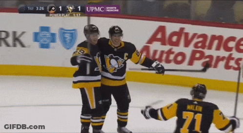 A Hockey Game Is Being Played In Front Of An Advance Auto Parts Ad GIF