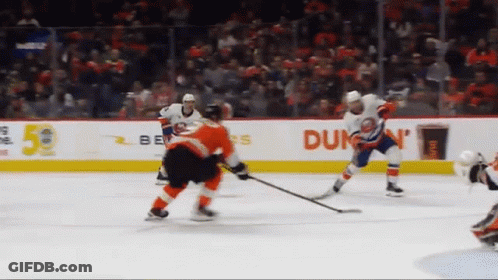 A Hockey Game Is Being Played In Front Of An Advertisement For Dunkin ' GIF