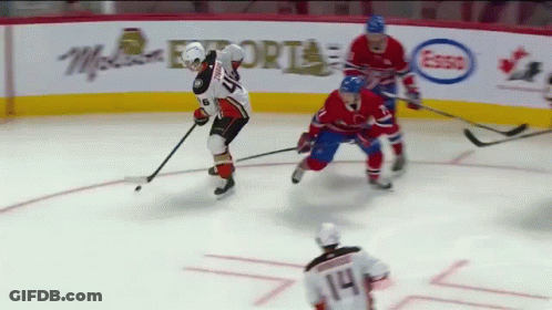 A Hockey Game Is Being Played In Front Of An Advertisement For Mcdonalds GIF
