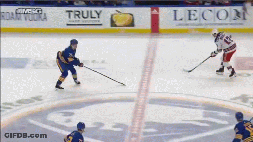 A Hockey Game Is Being Played In Front Of An Advertisement For Truly GIF