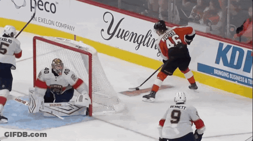 A Hockey Game Is Being Played In Front Of An Advertisement For Yuengling GIF