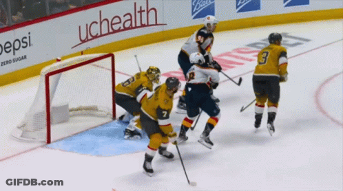 A Hockey Game Is Being Played In Front Of An Uchealth Sign GIF