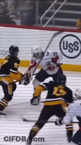 A Hockey Game Is Being Played In Front Of An Uss Advertisement GIF