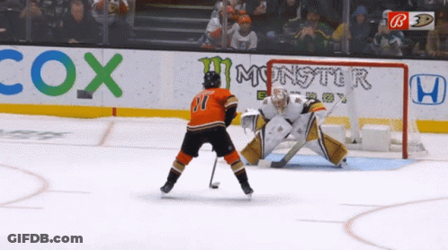 A Hockey Game Is Being Played In Front Of Cox Monster And Honda Ads GIF