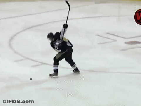 A Hockey Game Is Being Played On A Rink With Lumber Advertisements On The Walls GIF