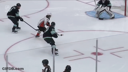 A Hockey Game Is Being Played On The Ice And The Goalie Is Wearing Bauer Gloves GIF