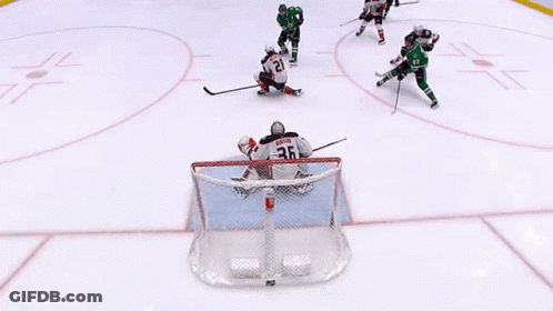 A Hockey Game Is Being Played With A Goalie Wearing Number 20 GIF