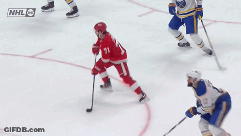 A Hockey Game Is Being Played With A Nhl Logo On The Ice GIF