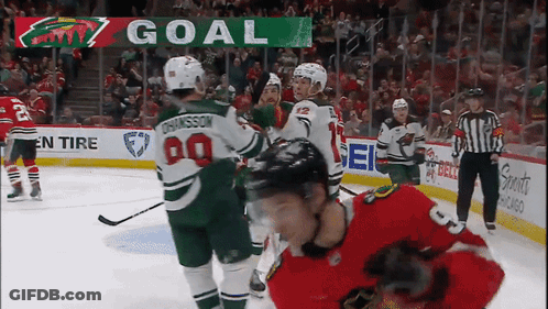 A Hockey Game Is Being Played With A Scoreboard That Says Goal On It GIF