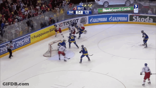 A Hockey Game Is Being Played With Ads For Skoda And Tissot On The Ice GIF