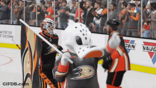 A Hockey Goalie And A Mascot On The Ice In Front Of A Sign That Says Ghn Vaughn GIF
