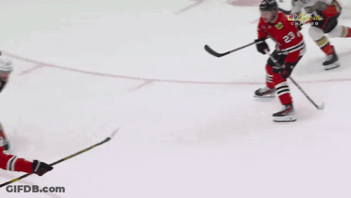 A Hockey Goalie Is Laying On The Ice In Front Of An Advertisement For Endeavor GIF