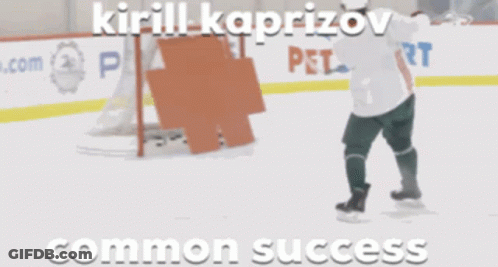 A Hockey Goalie Stands On The Ice With A Sign That Says Smart On It GIF