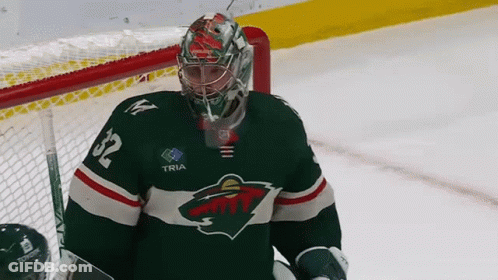 A Hockey Goalie Wearing A Jersey With The Number 32 On It GIF