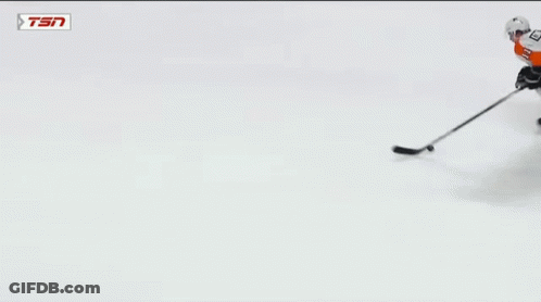 A Hockey Goalie With The Number 31 On His Jersey Makes A Save GIF