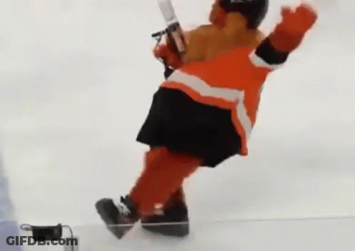 A Hockey Mascot Is Falling Down On The Ice While Holding A Hockey Stick . GIF