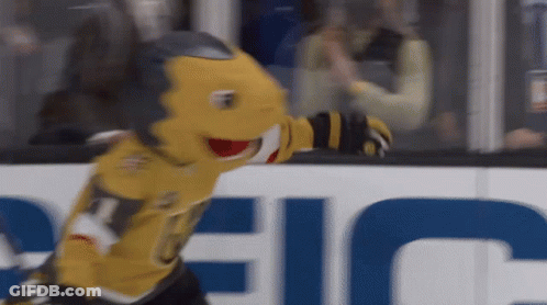 A Hockey Mascot Is Standing In Front Of A Sign That Says Eeic GIF