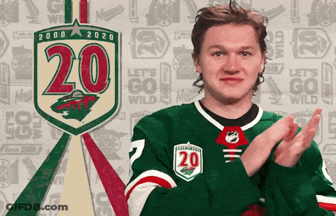 A Hockey Player Applauds In Front Of A Sign That Says 20 On It GIF