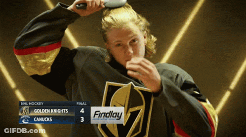A Hockey Player Brushing His Hair In Front Of A Scoreboard That Says Findlay On It GIF