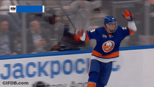 A Hockey Player Celebrates A Goal In Front Of A Banner That Says Jackpot GIF