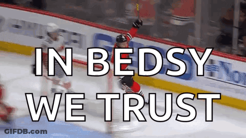 A Hockey Player Celebrates A Goal With The Words In Bedsy We Trust Below Him GIF