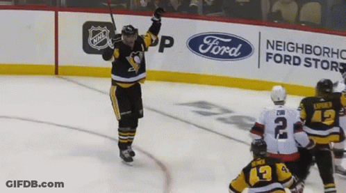A Hockey Player Celebrates His Goal In Front Of An Ad For Ford GIF