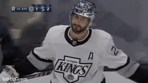 A Hockey Player For The Los Angeles Kings Is Standing On The Ice GIF
