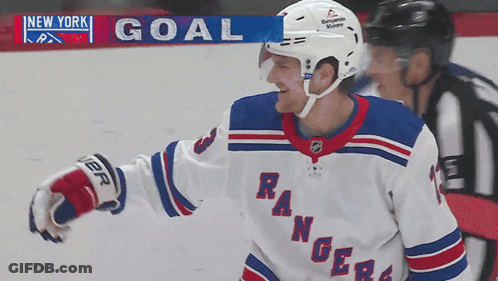 A Hockey Player For The New York Rangers Is Standing In Front Of A Scoreboard GIF
