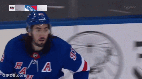 A Hockey Player For The New York Rangers Looks At The Camera GIF