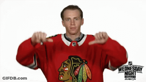 A Hockey Player Giving A Thumbs Down Sign In Front Of A Sign That Says Wednesday Night GIF